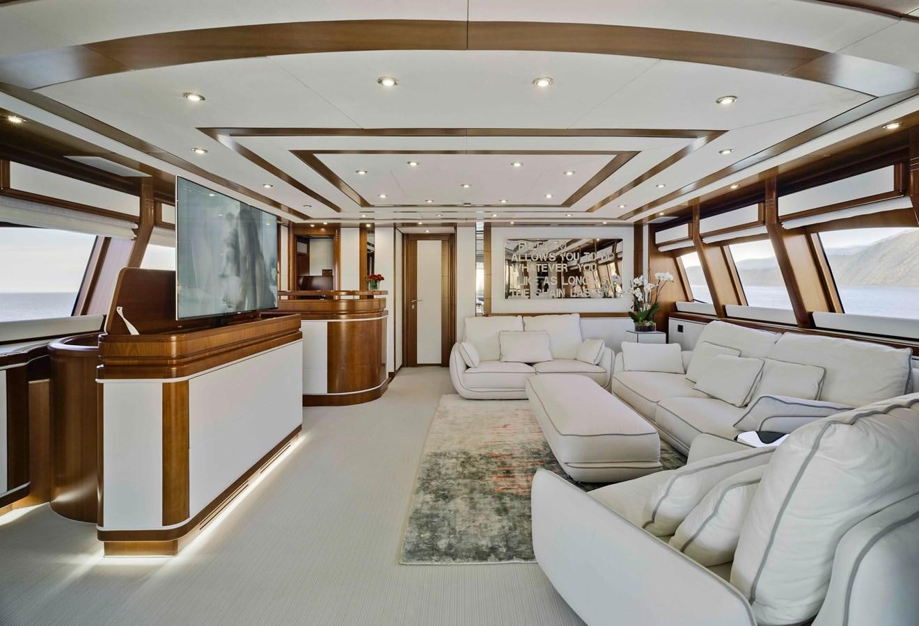 a room with a large window and a large table with chairs aboard BUNKER Yacht for Sale
