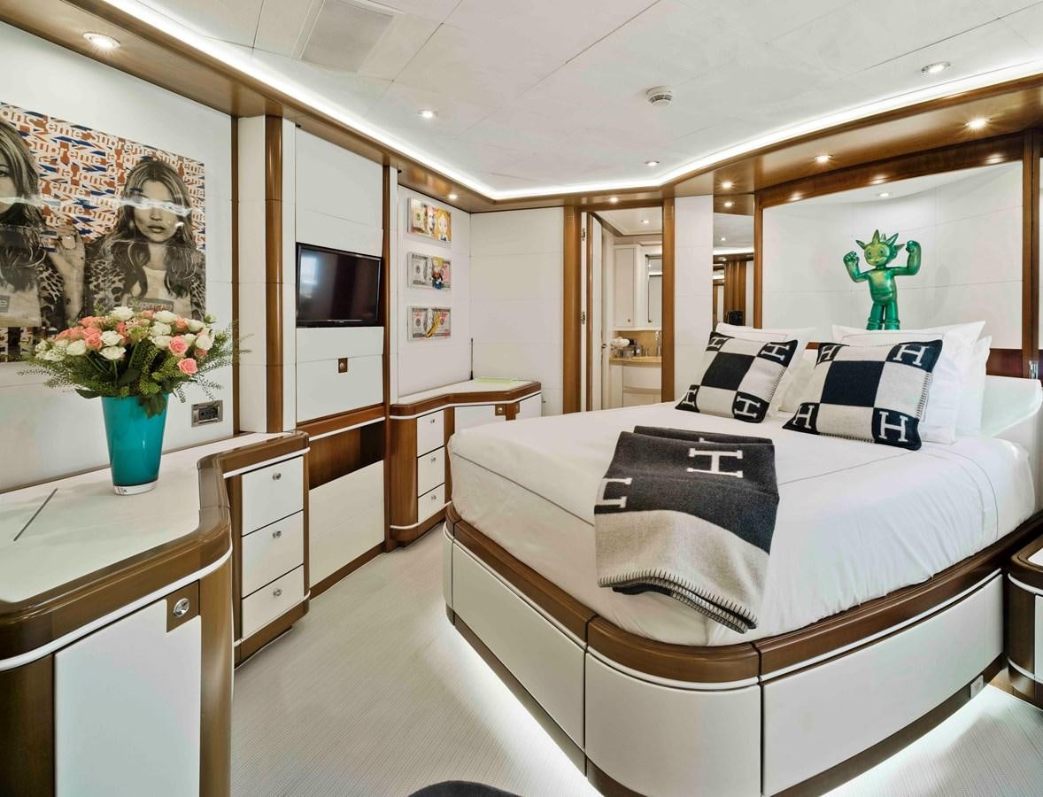 a bedroom with a bed and a desk aboard BUNKER Yacht for Sale