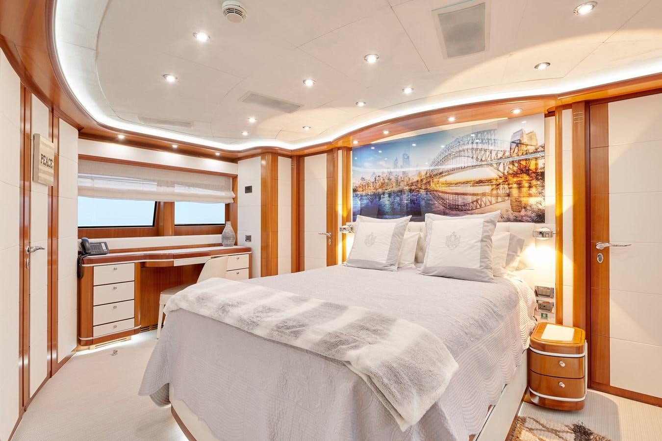 a bedroom with a bed and a mirror aboard BUNKER Yacht for Sale