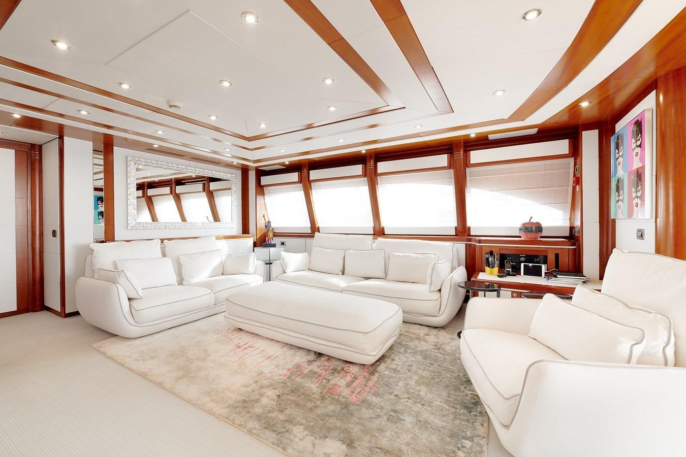 a living room with white couches aboard BUNKER Yacht for Sale