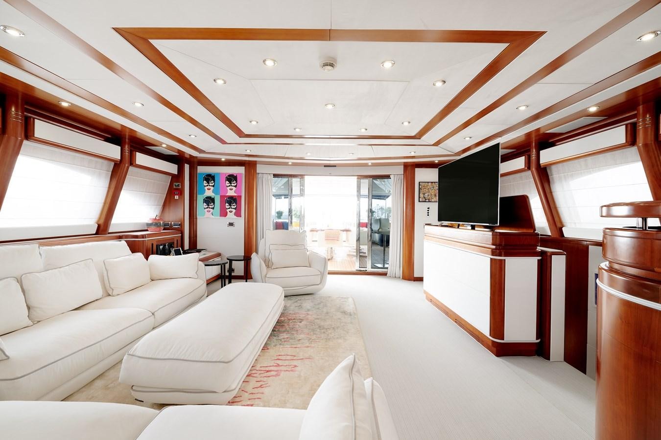 a living room with a large screen aboard BUNKER Yacht for Sale