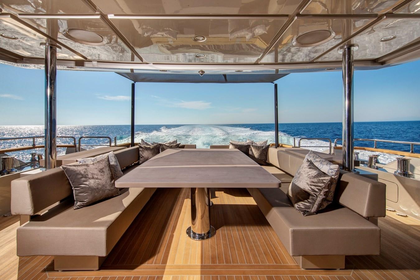 a room with couches and a table aboard CANADOS 122’ CAESAR RPH Yacht for Sale