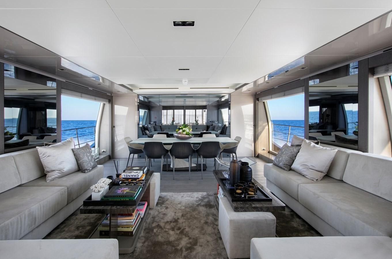 a living room with a couch and a table aboard CANADOS 122’ CAESAR RPH Yacht for Sale