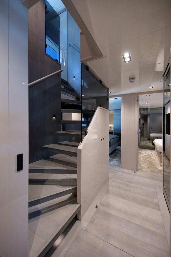 a hallway with blue doors aboard CANADOS 122’ CAESAR RPH Yacht for Sale