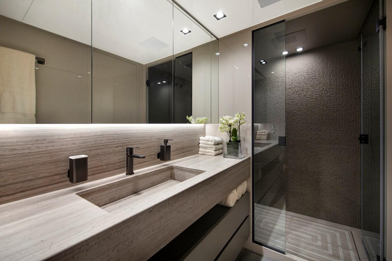 a bathroom with a large mirror aboard CANADOS 122’ CAESAR RPH Yacht for Sale