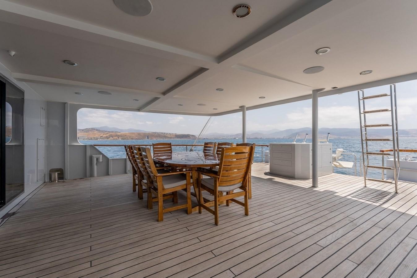 a room with a table and chairs aboard HARDHOME Yacht for Sale