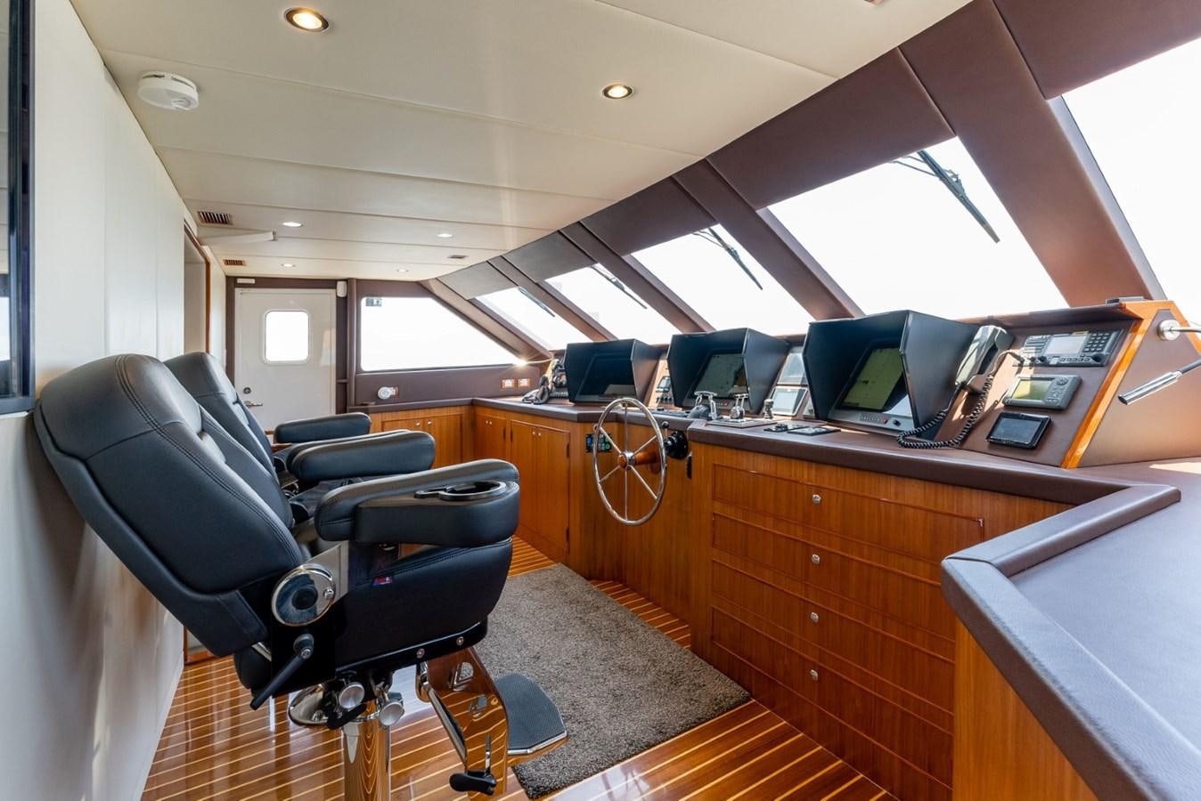 a room with a desk and chairs aboard HARDHOME Yacht for Sale