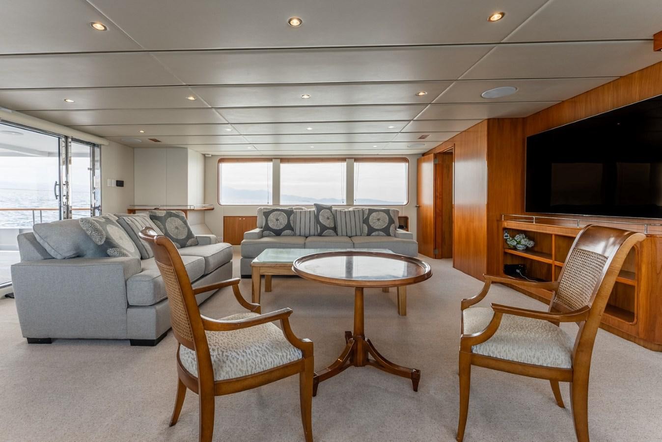 a living room with a couch and a table aboard HARDHOME Yacht for Sale