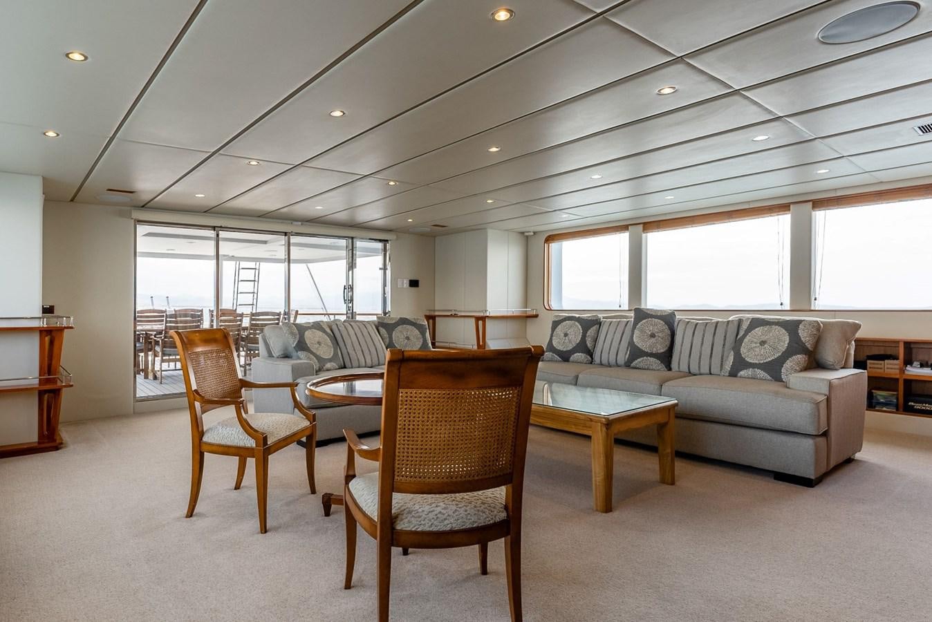 a living room with a couch and a table aboard HARDHOME Yacht for Sale