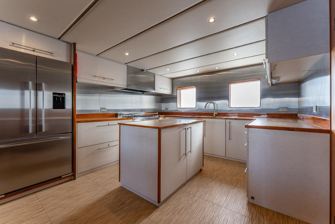 a kitchen with a large island aboard HARDHOME Yacht for Sale