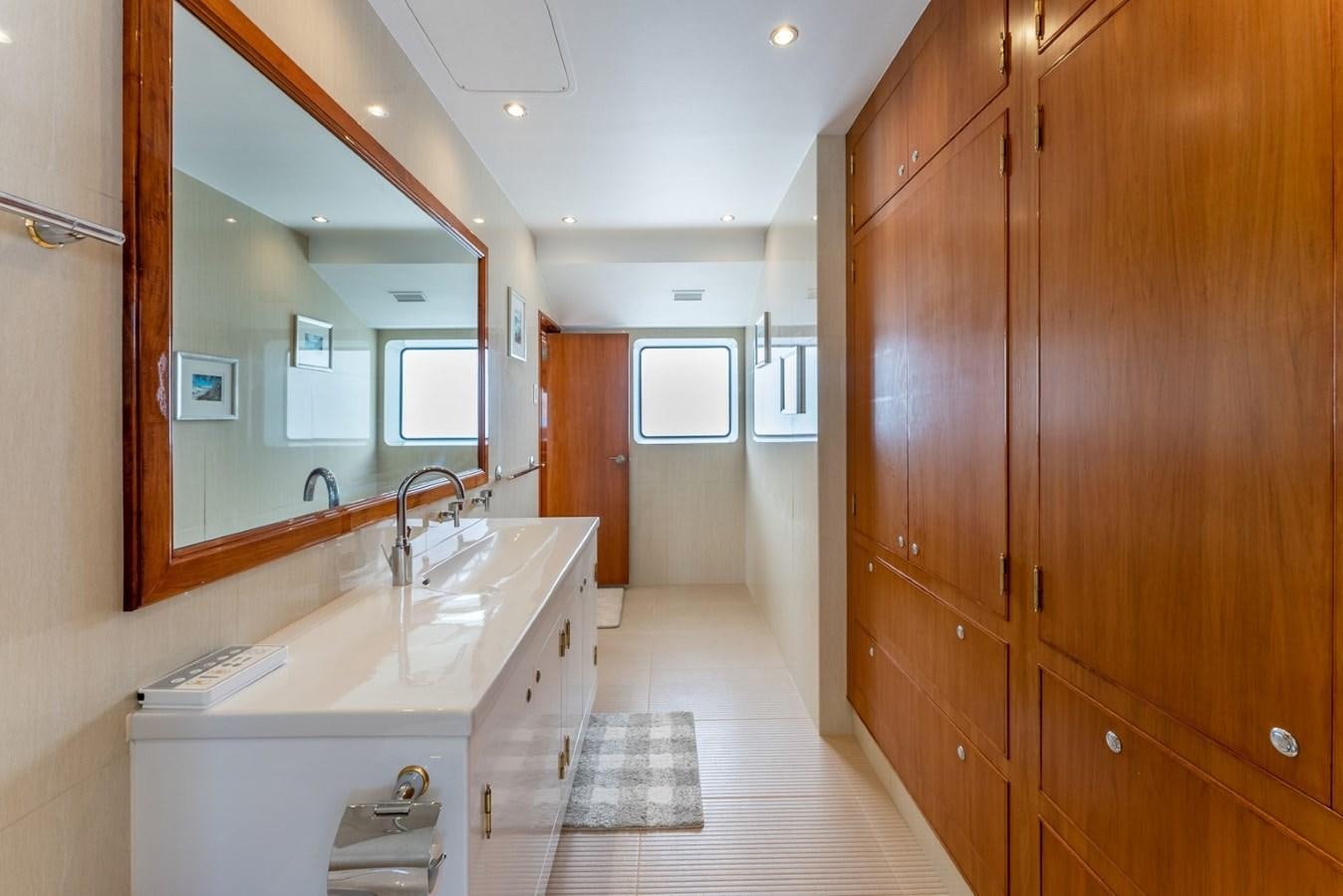 a bathroom with a large mirror aboard HARDHOME Yacht for Sale