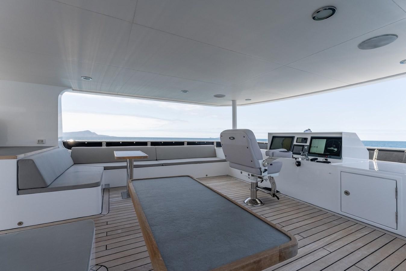 a room with a desk and chairs aboard HARDHOME Yacht for Sale