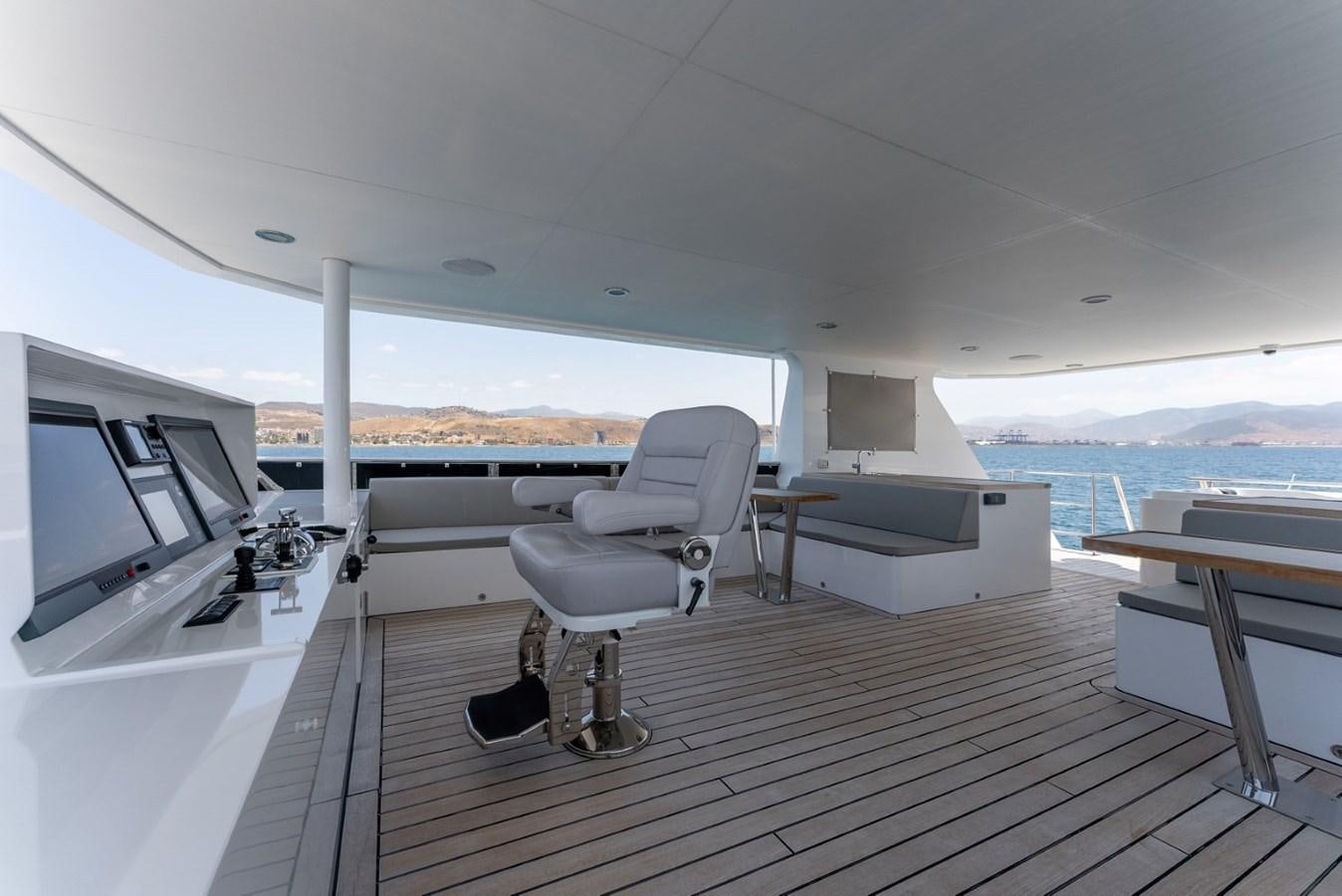 a room with a view of the ocean and a deck aboard HARDHOME Yacht for Sale