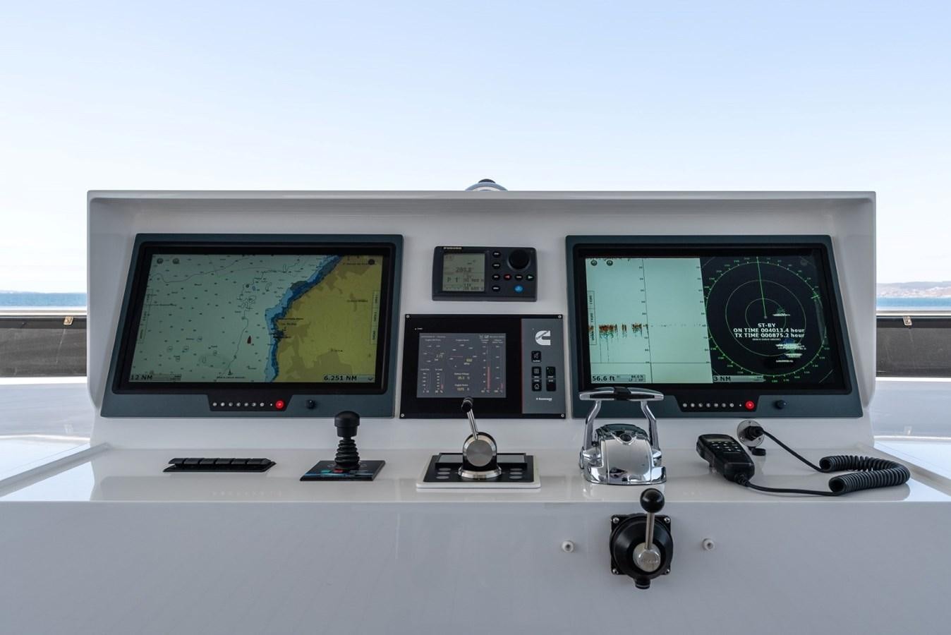 a computer with a monitor and a couple of monitors aboard HARDHOME Yacht for Sale