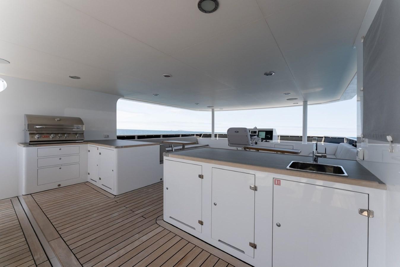 a kitchen with white cabinets aboard HARDHOME Yacht for Sale
