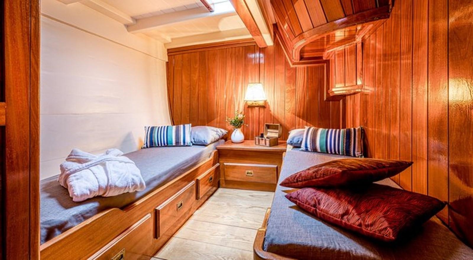 a room with a bed and a desk aboard O'REMINGTON Yacht for Sale