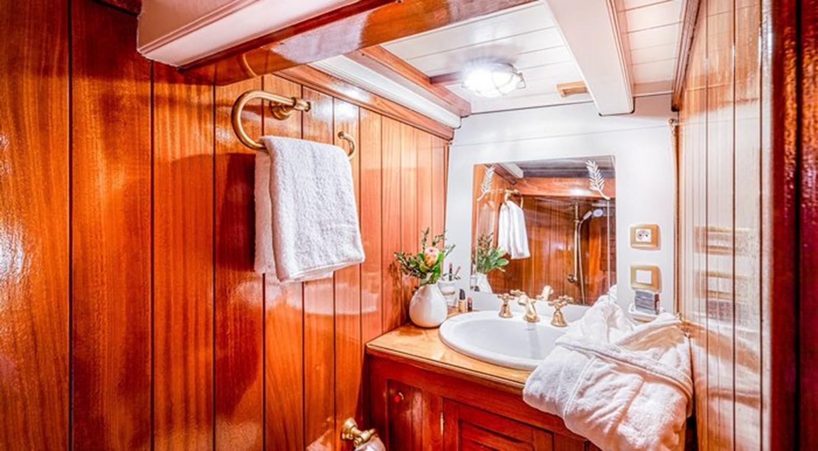 a bathroom with a sink and a mirror aboard O'REMINGTON Yacht for Sale