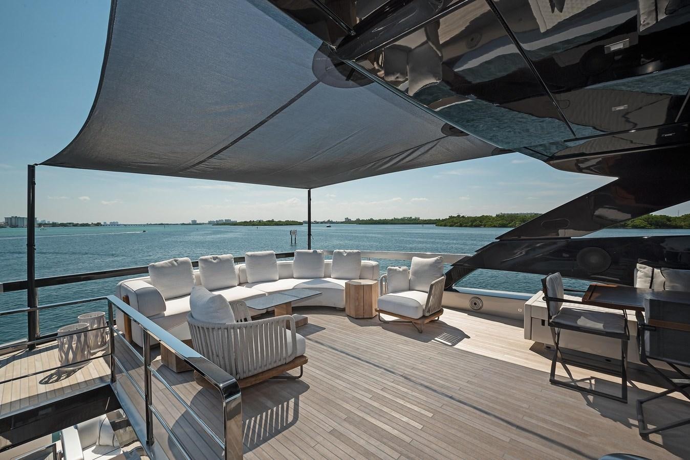 a deck with chairs and a large body of water in the background aboard ALLEGRA Yacht for Sale