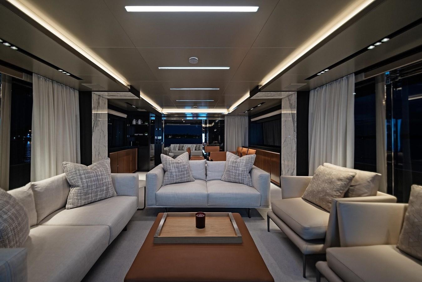 a living room with a table and couches aboard ALLEGRA Yacht for Sale