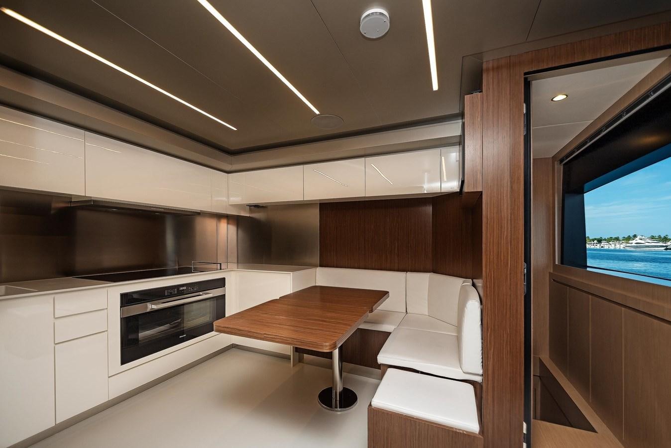 a kitchen with a table and chairs aboard ALLEGRA Yacht for Sale