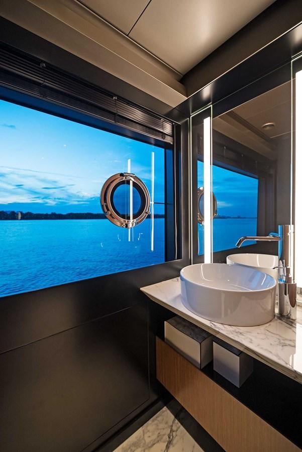 a bathroom with a sink and a large window aboard ALLEGRA Yacht for Sale