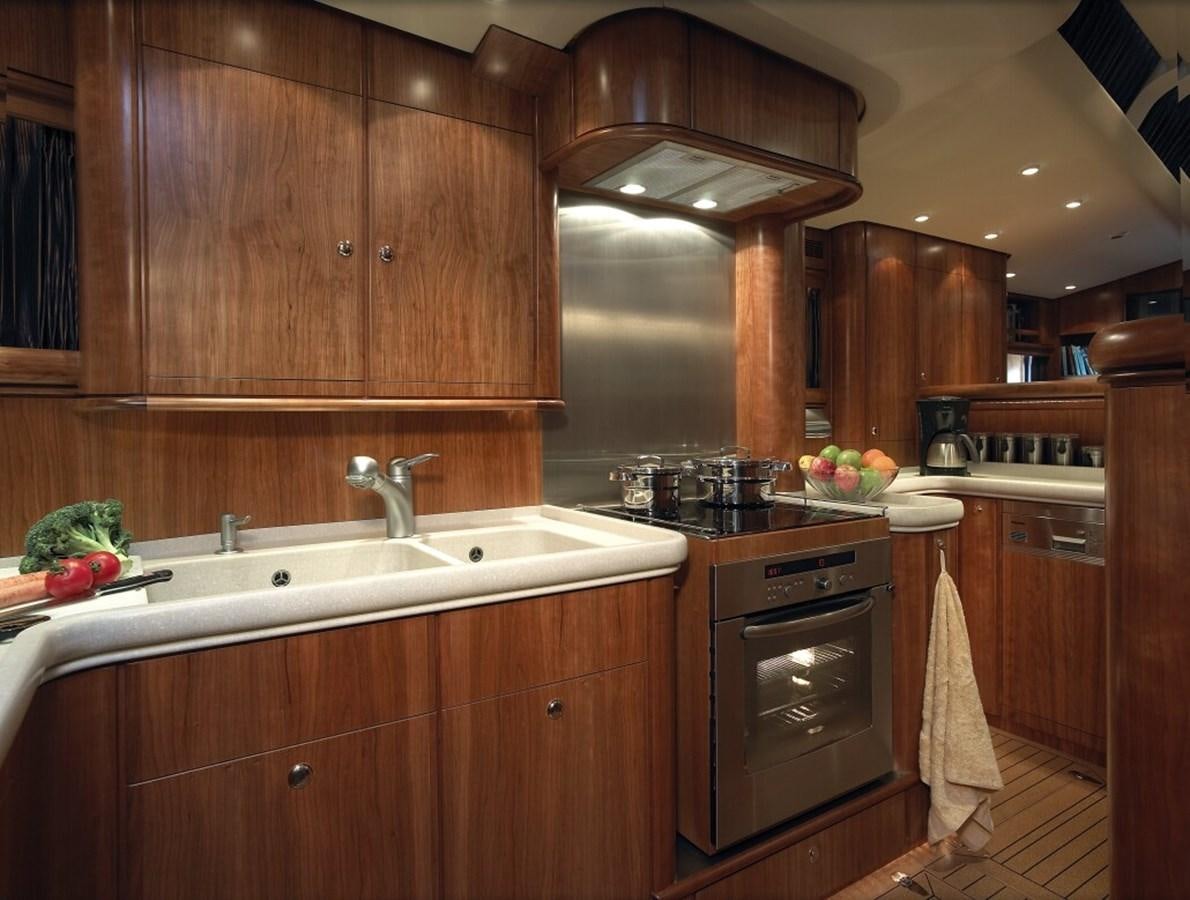 a kitchen with wooden cabinets aboard SULTANA Yacht for Sale