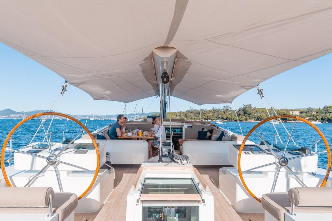 a group of people sitting at a table on a boat aboard GRAND BLEU VINTAGE Yacht for Sale
