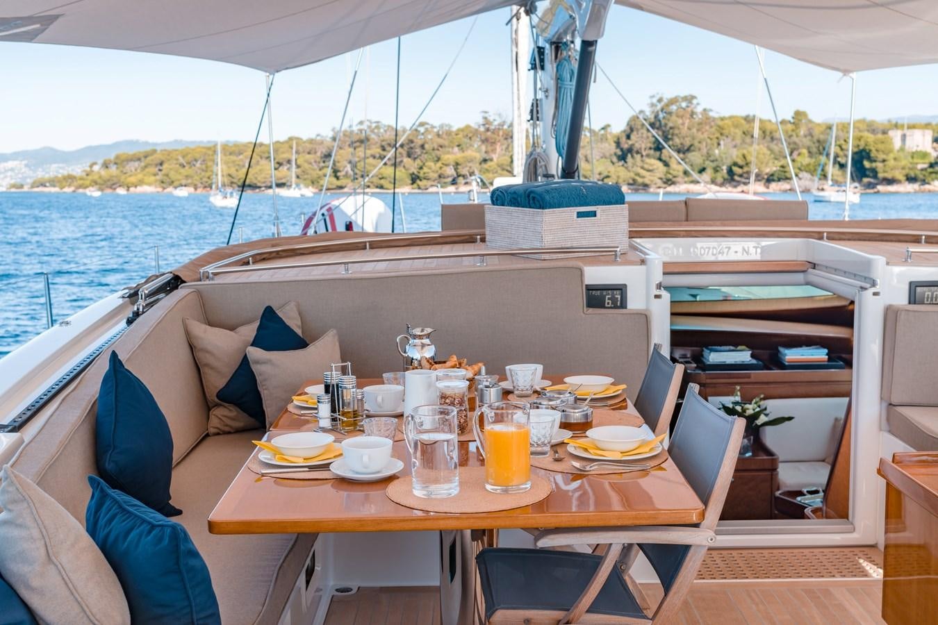 a table with food and drinks on it aboard GRAND BLEU VINTAGE Yacht for Sale
