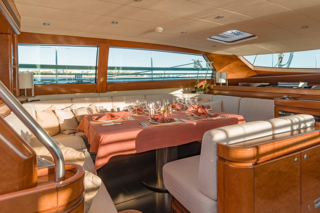 a room with a table and chairs aboard GRAND BLEU VINTAGE Yacht for Sale