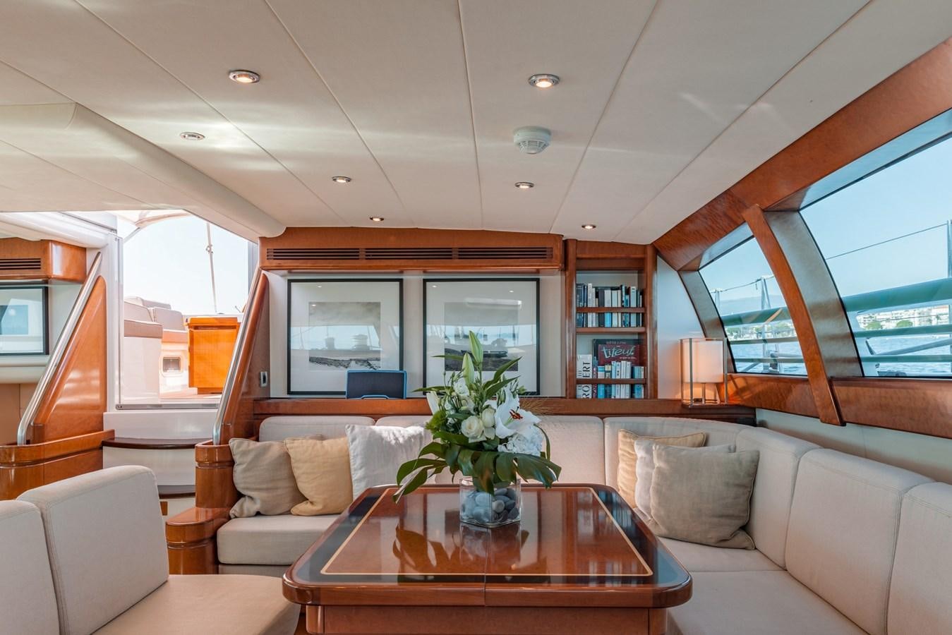 a living room with a table and couches aboard GRAND BLEU VINTAGE Yacht for Sale