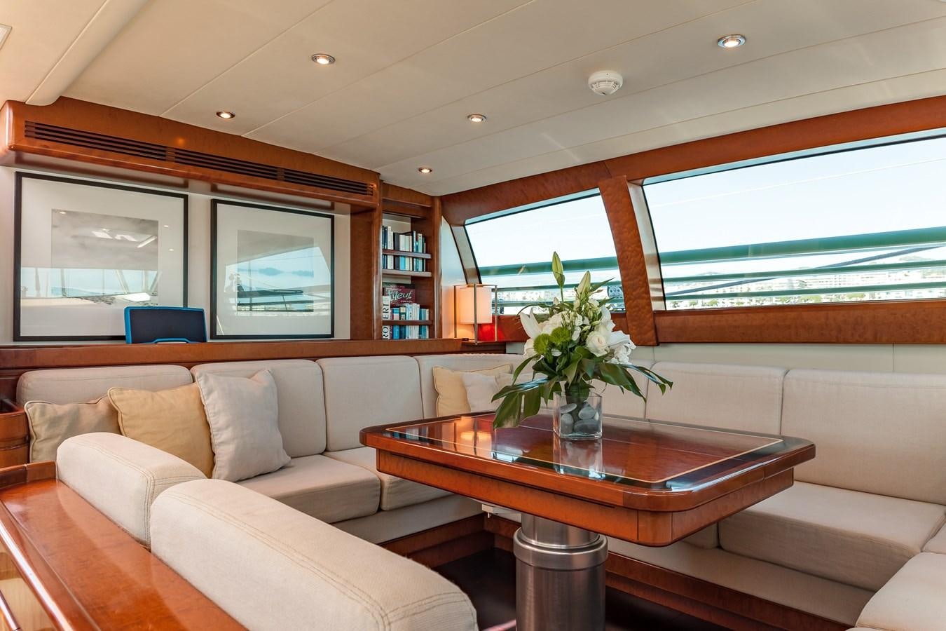 a living room with a table and couches aboard GRAND BLEU VINTAGE Yacht for Sale