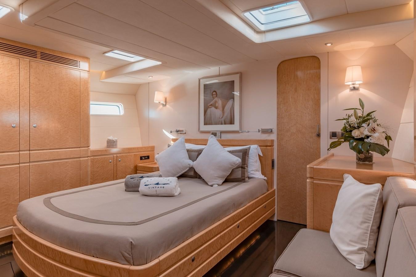 a room with a bed and a table aboard GRAND BLEU VINTAGE Yacht for Sale