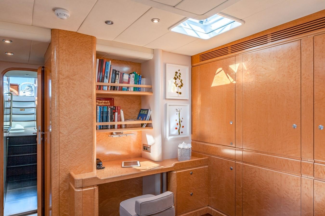 a room with a desk and a bookcase aboard GRAND BLEU VINTAGE Yacht for Sale