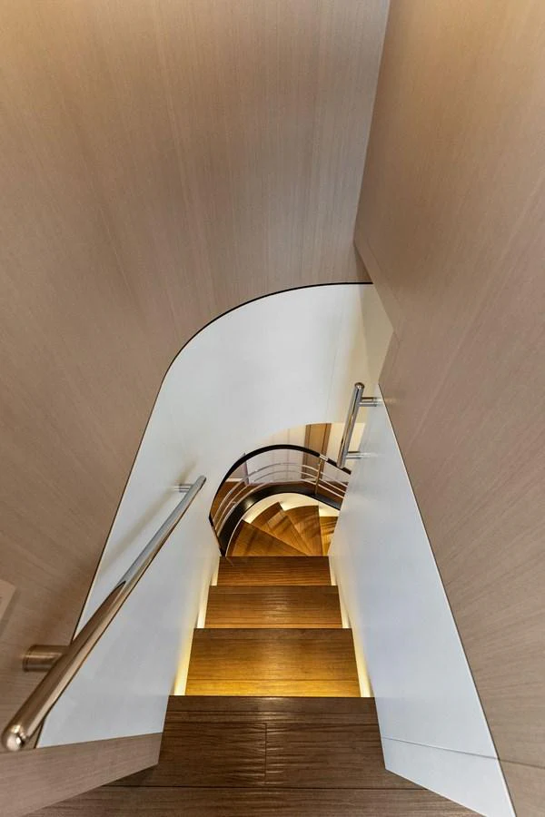 a staircase with a metal railing aboard LADY K Yacht for Sale