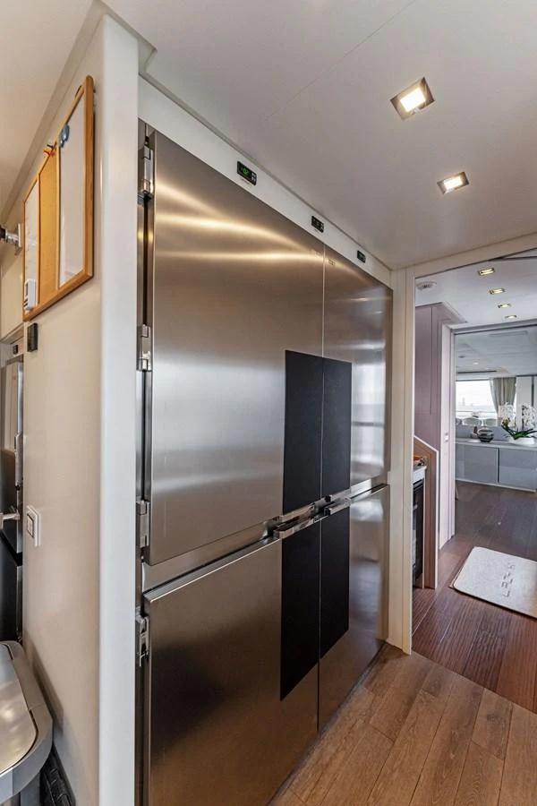 a stainless steel refrigerator in a kitchen aboard LADY K Yacht for Sale