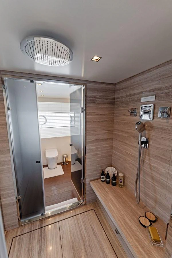 a bathroom with a shower unit and a mirror aboard LADY K Yacht for Sale