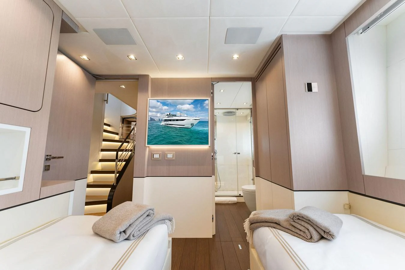 a room with a bed and a television aboard LADY K Yacht for Sale