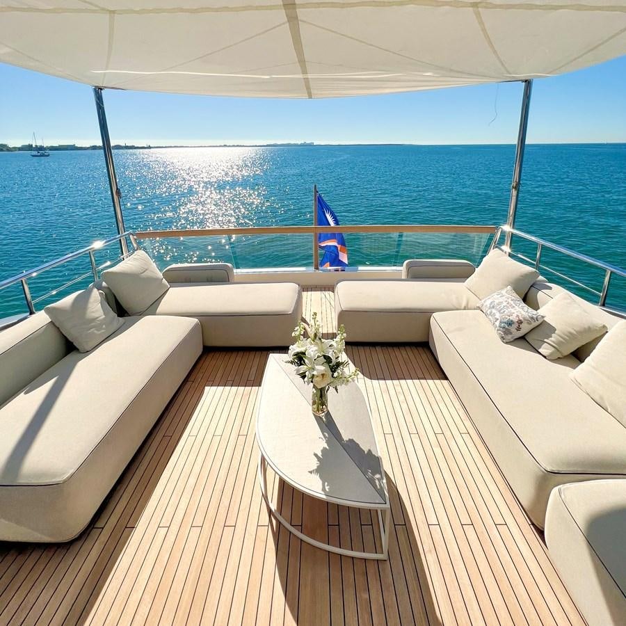 a room with a large white sofa and a large body of water aboard C-DAZE Yacht for Sale