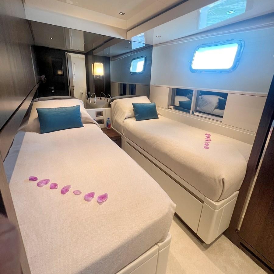 a room with beds and a window aboard C-DAZE Yacht for Sale