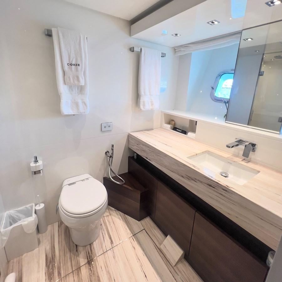 a bathroom with a sink toilet and a mirror aboard C-DAZE Yacht for Sale