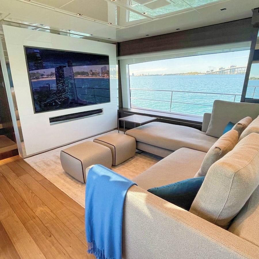 a living room with a large screen aboard C-DAZE Yacht for Sale