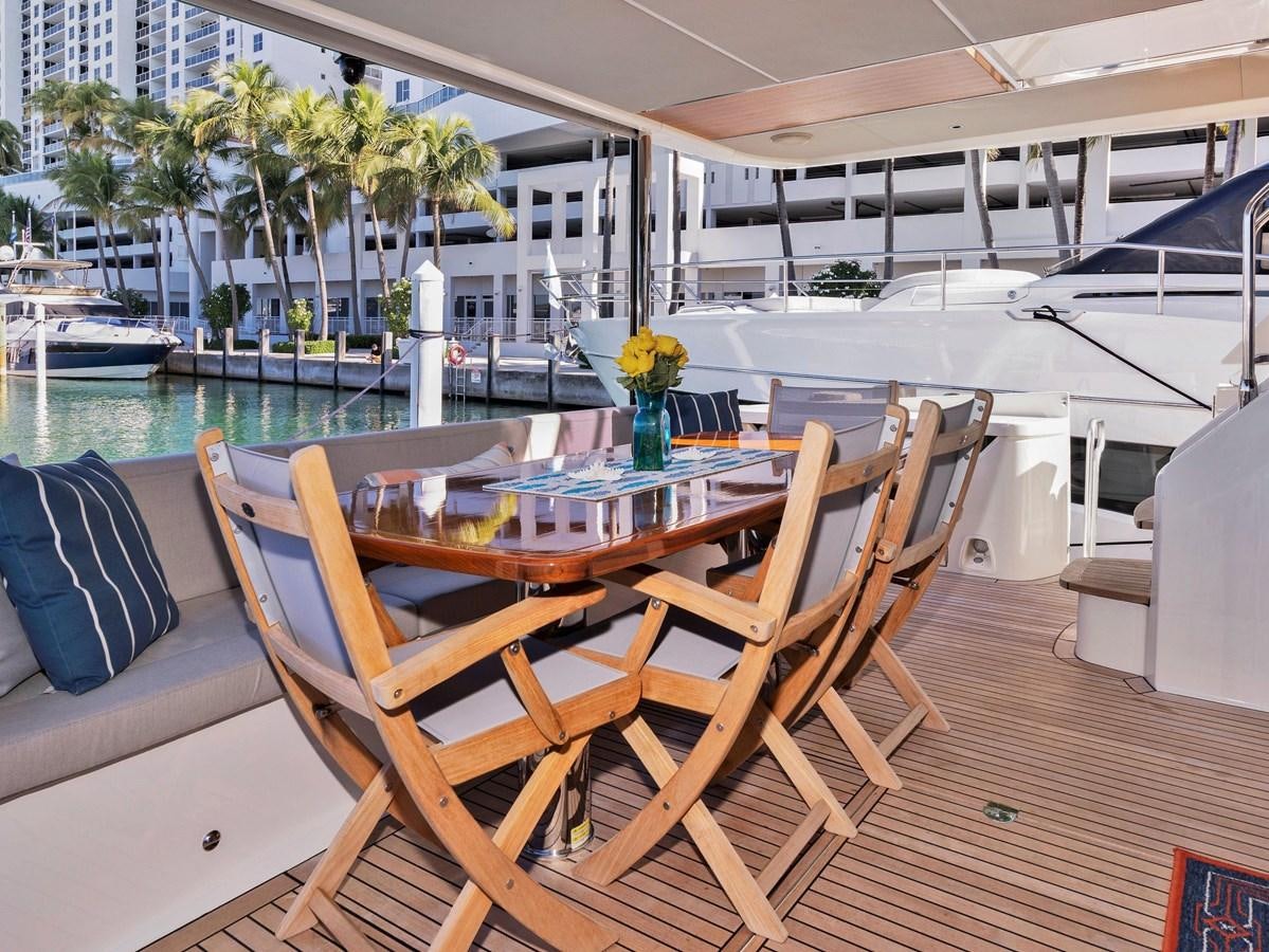 a table and chairs on a deck aboard POWERSFUL Yacht for Sale
