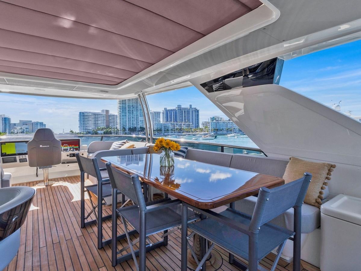 a table and chairs on a deck aboard POWERSFUL Yacht for Sale
