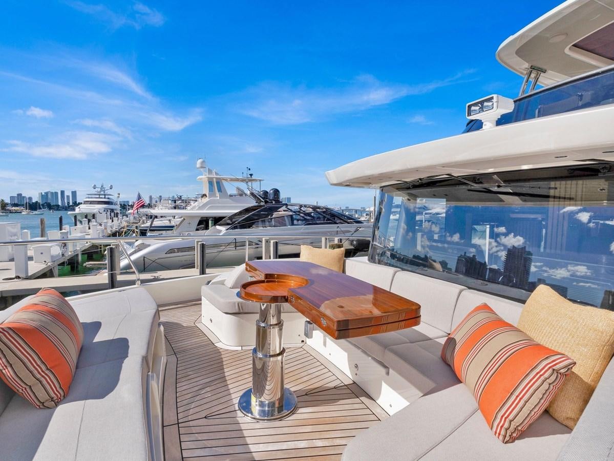 a deck with a view of a city and a large ship aboard POWERSFUL Yacht for Sale