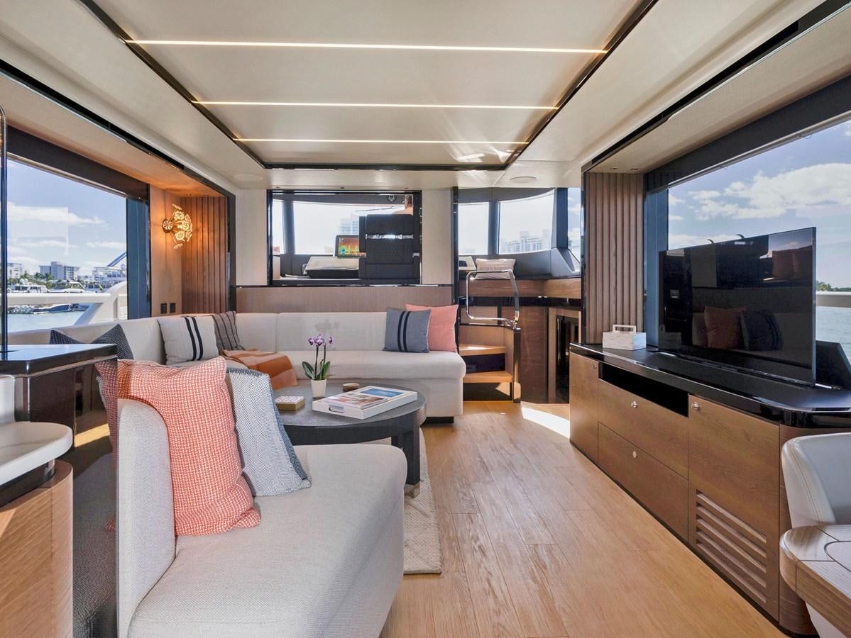 a living room with a tv and furniture aboard POWERSFUL Yacht for Sale