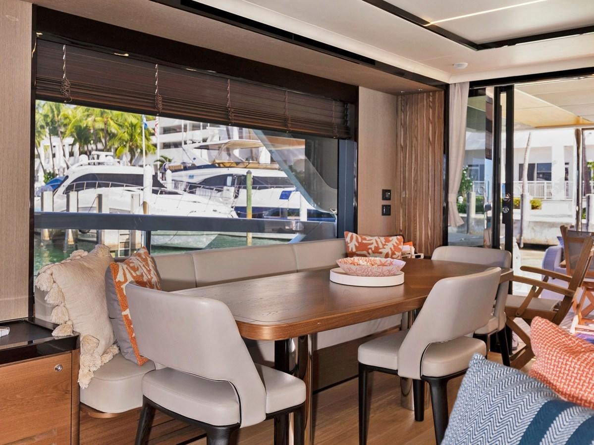 a table with chairs and a view of the water aboard POWERSFUL Yacht for Sale