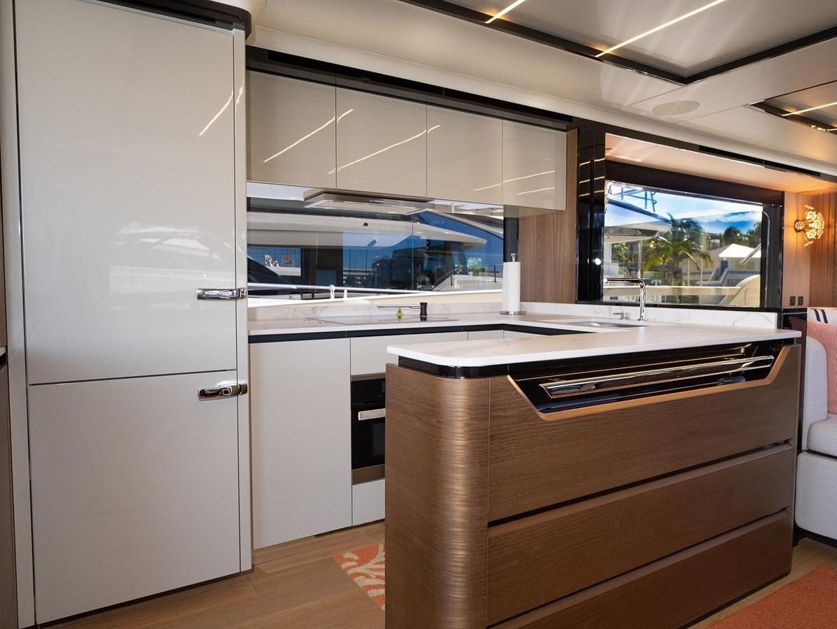 a kitchen with white cabinets aboard POWERSFUL Yacht for Sale
