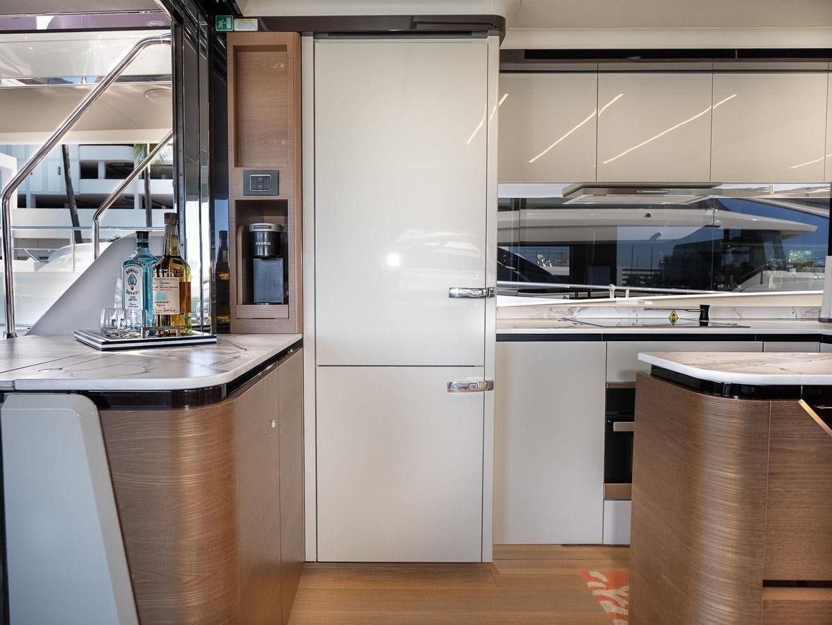 a refrigerator in a kitchen aboard POWERSFUL Yacht for Sale
