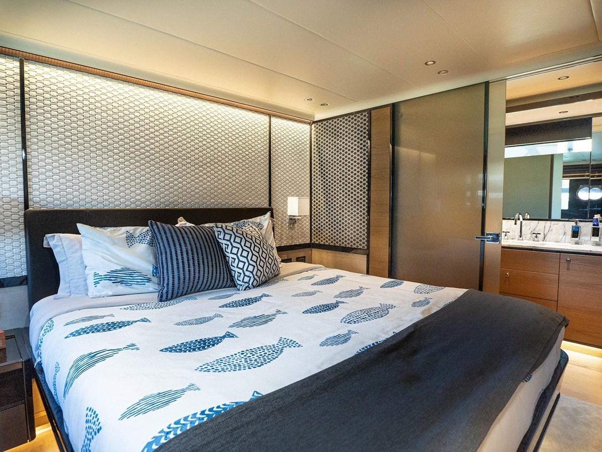 a bed with blue and white sheets aboard POWERSFUL Yacht for Sale