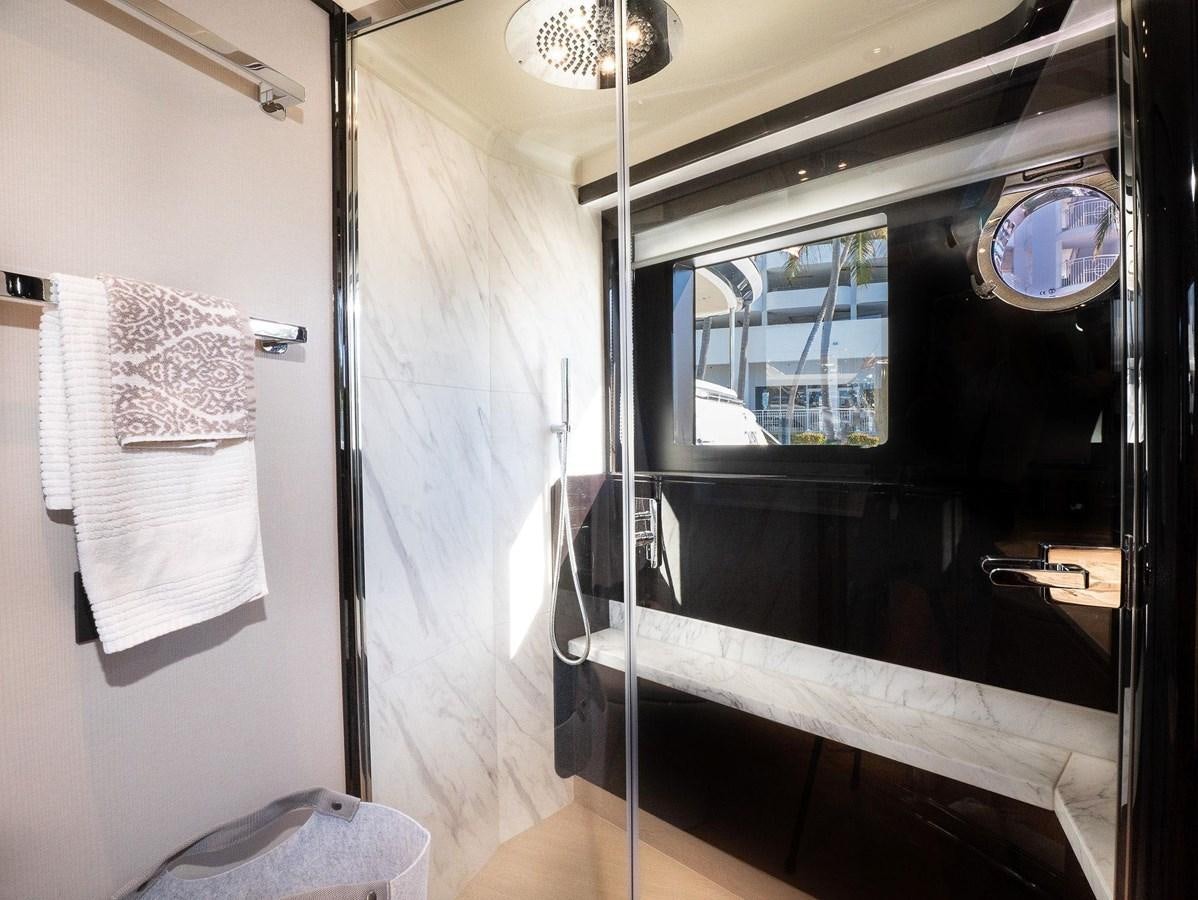 a bathroom with a glass shower aboard POWERSFUL Yacht for Sale